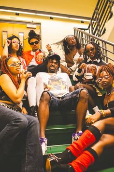 a group of young people sitting on the stairs