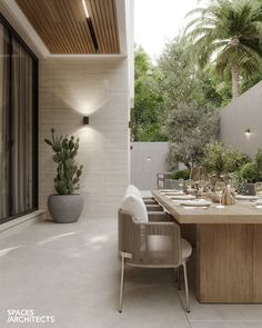 an outdoor dining area with table, chairs and potted plants on the side wall