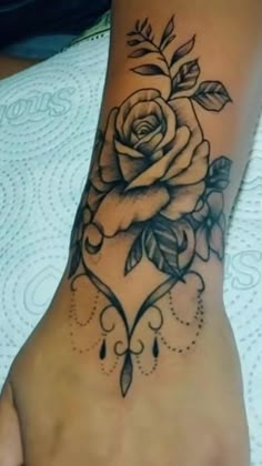 a foot with a rose tattoo on it