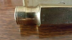 a close up view of a metal object on a wooden table