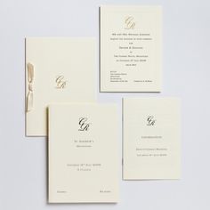 the wedding stationery is laid out on top of each other