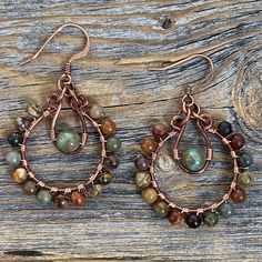 Red Creek Jasper and Czech Glass Hoop Dangle Earrings wrapped with copper wire and includes a Nickel Free Ear-Wire: These earrings are light weight, comfortable, simple and fun. Throw them on with any outfit and they will definitely add some pop They are approximately 2 inches in length and 1.25 inches at the widest portion. All of these items are handmade so please allow for possible slight variance in sizing. If you would like these in a different color or size, please let me know as I also do Jewelry Rustic, Boho Hoop Earrings, Earthy Jewelry, Indie Jewelry, Earrings Stone, Dope Jewelry, Handmade Wire Jewelry, Earrings Hoop, Funky Jewelry