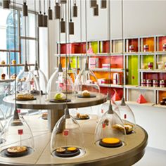 a room filled with lots of different types of food on top of glass shelves next to each other