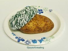 there is a potato on a plate with a green and white cloth wrapped around it