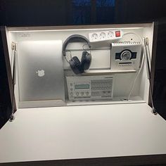 an apple computer with headphones in a display case