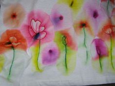 an artistically painted t - shirt with flowers on it