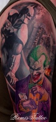 a man with a tattoo on his arm that has the joker and cat in it