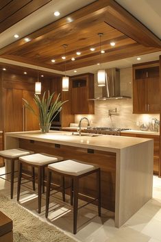 a kitchen with an island and stools in front of the counter top, along with wooden cabinets