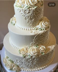 a three tiered wedding cake with white flowers