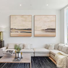 a living room with two paintings on the wall