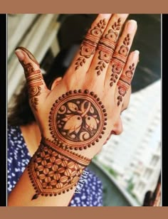 a woman holding her hands up to show the intricate design on her hand and wrist