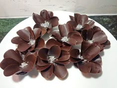 there are chocolate flowers on the white plate