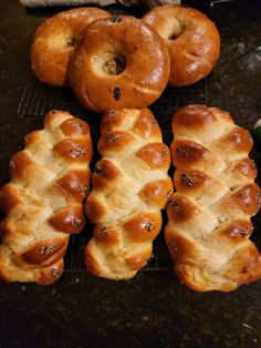 hot cross buns lined up on a cooling rack next to each other with holes in the middle