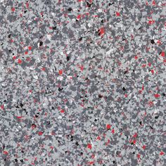 an image of red and black speckles on concrete