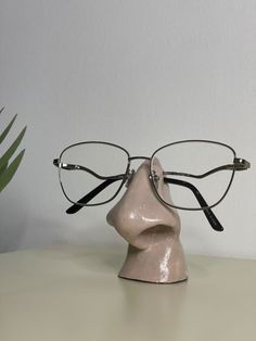 a pair of glasses sitting on top of a head