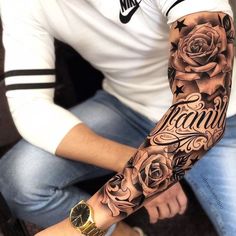 a man with a rose tattoo on his arm is sitting in front of the camera