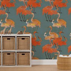 a wallpaper with flamingos on it and baskets in the foreground, against a blue background