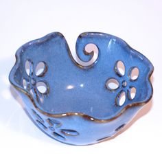 a small blue bowl sitting on top of a white table