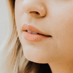 a close up of a woman's nose with a nose ring on her nose