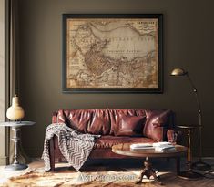 a living room with a brown leather couch and a map on the wall above it