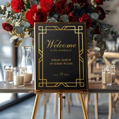 a welcome sign sitting on top of a wooden table next to vases filled with flowers