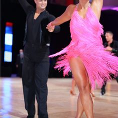 a man and woman dancing on the dance floor