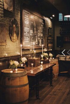 an old fashioned bar with candles and wine barrels