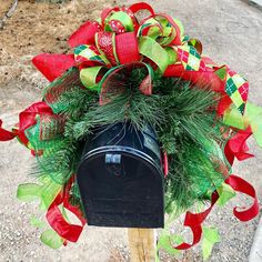 a mailbox decorated with green and red bows