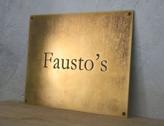 a metal sign that says fausto's on it