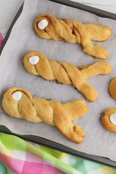 pastries with marshmallows in the shape of dogs on a baking sheet