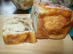 two pieces of bread sitting on top of a wooden cutting board