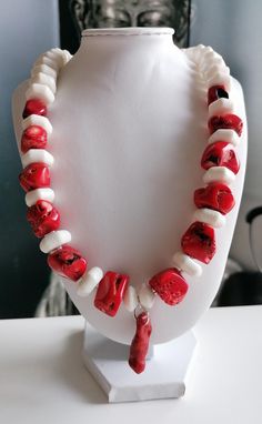 Handmade red/white coral necklace with pendant. The length of the two-tone chain is approx. 54 cm plus an extension chain. The statement necklace is made from natural coral beads in irregular shape in red (12 mm - 27 mm), white hexagonal coral beads (15 mm x 7 mm) and white coral beads in discus shape (13 mm x 7 mm). The length of the chain pendant made of coral branch is approx. 30 mm. Between the white hexagonal beads there are red branch coral beads (5 mm - 8 mm). S-clasps, pearl caps and the Red Coral Necklaces For Gifts, White Shell Necklace With Lobster Clasp As Gift, Red Coral Necklaces As Gifts, Coral Red Coral Necklace For Gifts, Unique White Pendant Necklace, Single Strand Red Coral Necklace As Gift, Red Single Strand Necklace For Gift, Coral Red Coral Necklace Gift, Unique Red Coral Necklace For Gifts