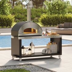 an outdoor bbq grill sitting next to a swimming pool