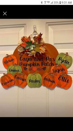 pumpkins and leaves are hanging on the front door with names in different languages that spell autumn