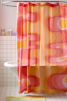 a shower curtain with an orange and pink design on it