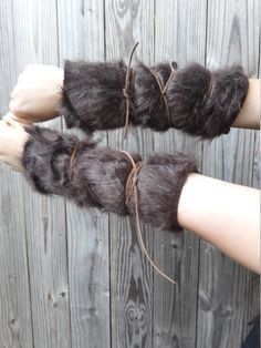 two hands are shown with furry gloves on them