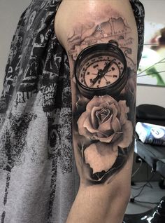 a man with a clock and rose tattoo on his arm