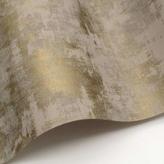 a close up view of a gold and white wallpaper