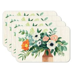 four coasters with flowers in a vase on top of each one and green leaves