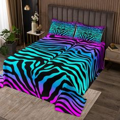 a bed with a zebra print comforter and pillows