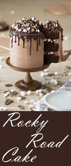 a cake with chocolate frosting and sprinkles sitting on top of a table