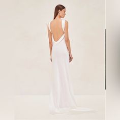 a woman in a white dress looking back