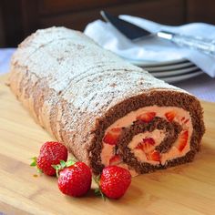 there is a roll with strawberries on the table