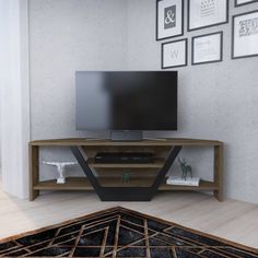 a flat screen tv sitting on top of a wooden entertainment center in a living room