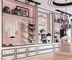 a pink and white closet with lots of clothes on shelves, shoes and bras hanging from the ceiling