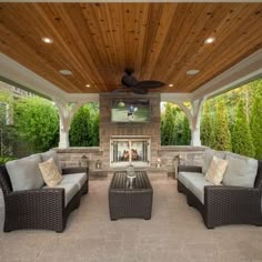 an outdoor living area with couches and tables