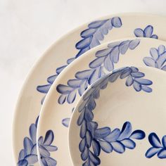 three blue and white plates sitting on top of each other