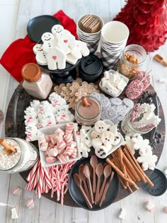 a platter filled with lots of different types of treats and candy canes on top of a table