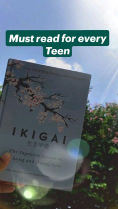 a person holding up a book with the title must read for every teen