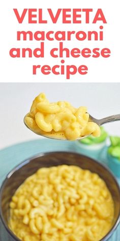 a spoon full of macaroni and cheese is being held up over the bowl